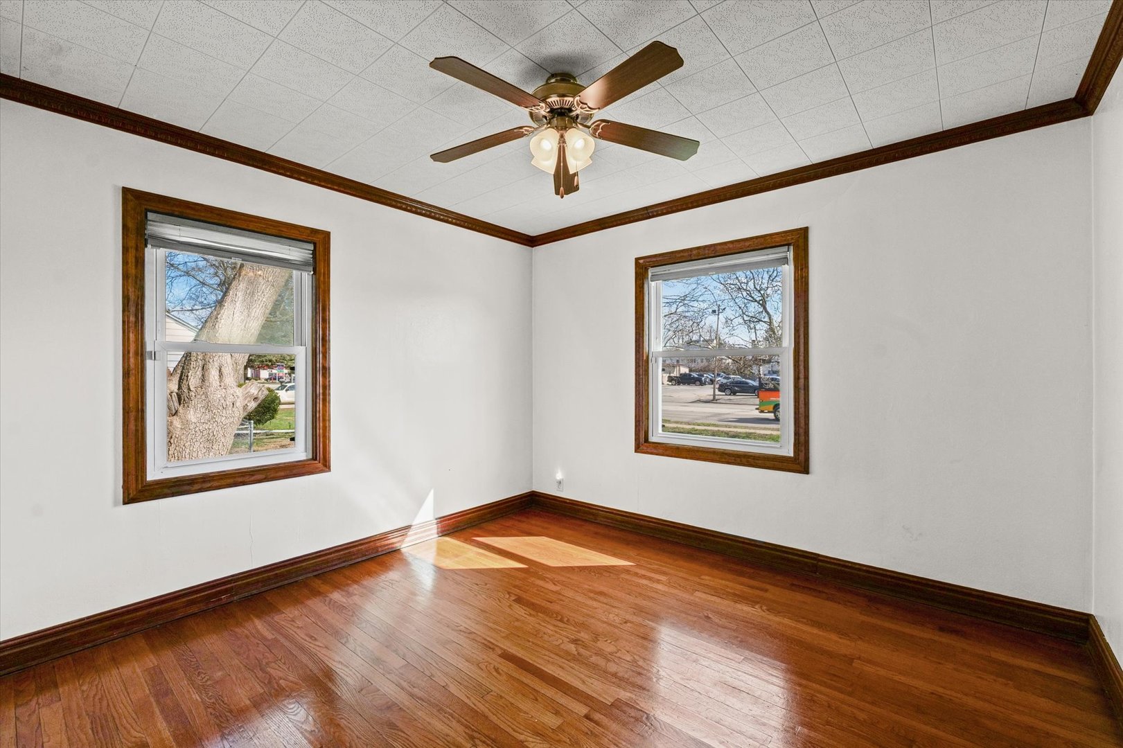1608 West Springfield Avenue Champaign, IL 61821 - Photo 15 of 36 a view of a hallway with wooden floor and a ceiling fan