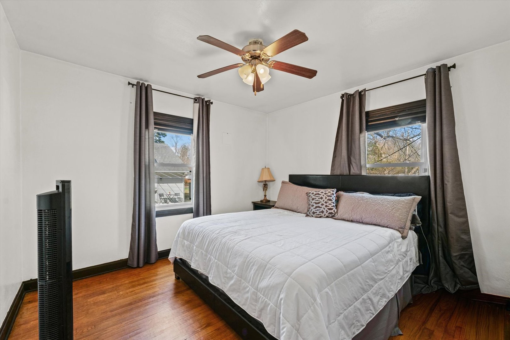 1608 West Springfield Avenue Champaign, IL 61821 - Photo 17 of 36 a bedroom with a large bed and a large mirror