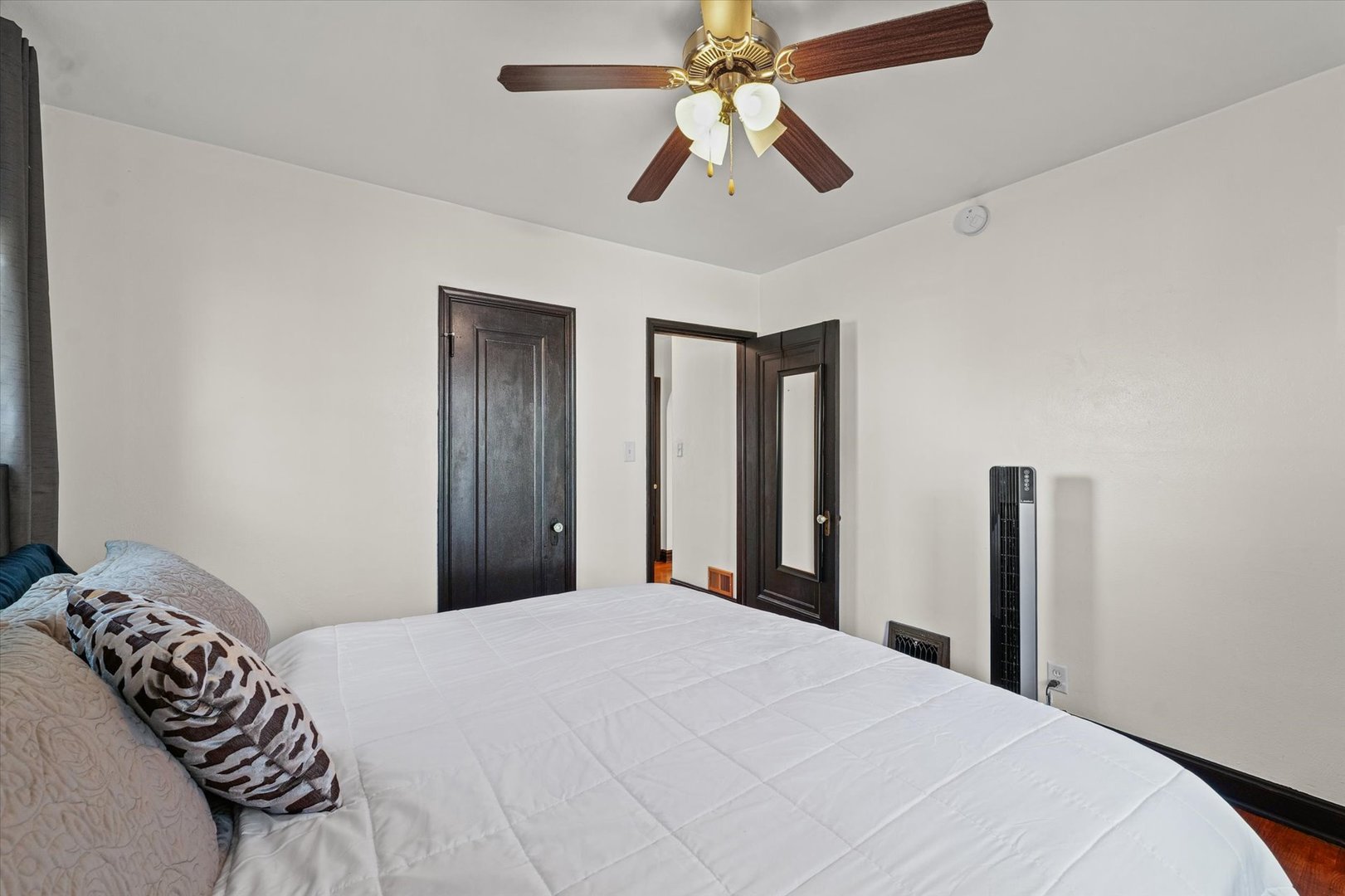 1608 West Springfield Avenue Champaign, IL 61821 - Photo 18 of 36 a bedroom with a large bed and a chandelier