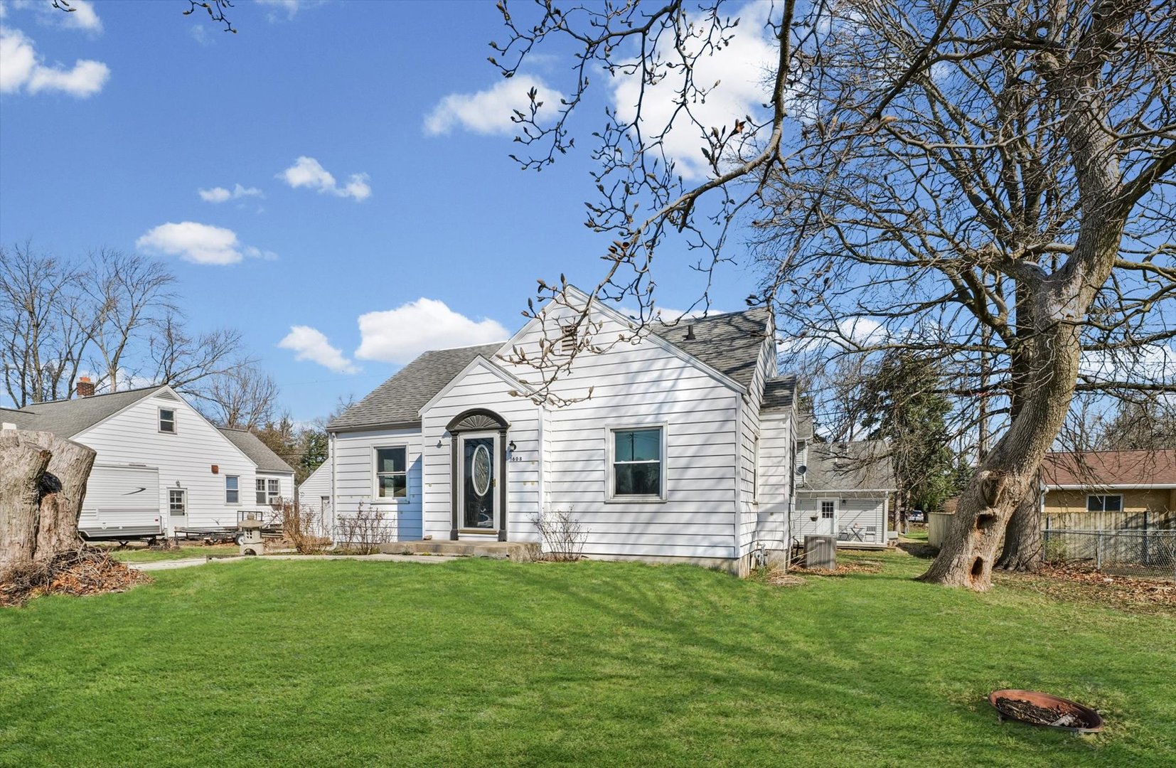 1608 West Springfield Avenue Champaign, IL 61821 - Photo 2 of 36 a front view of a house with a garden