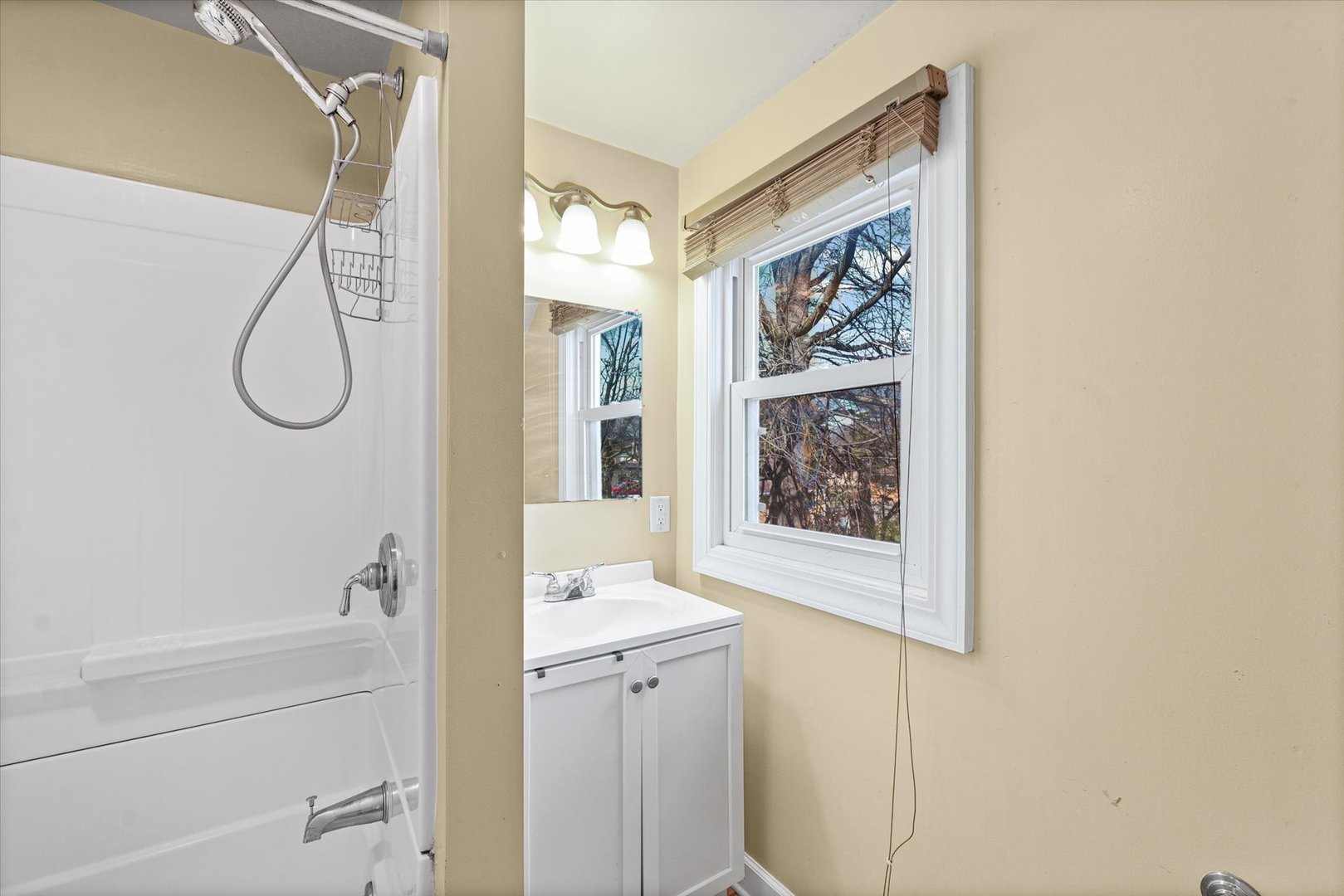 1608 West Springfield Avenue Champaign, IL 61821 - Photo 27 of 36 a bathroom with a shower curtain and a window