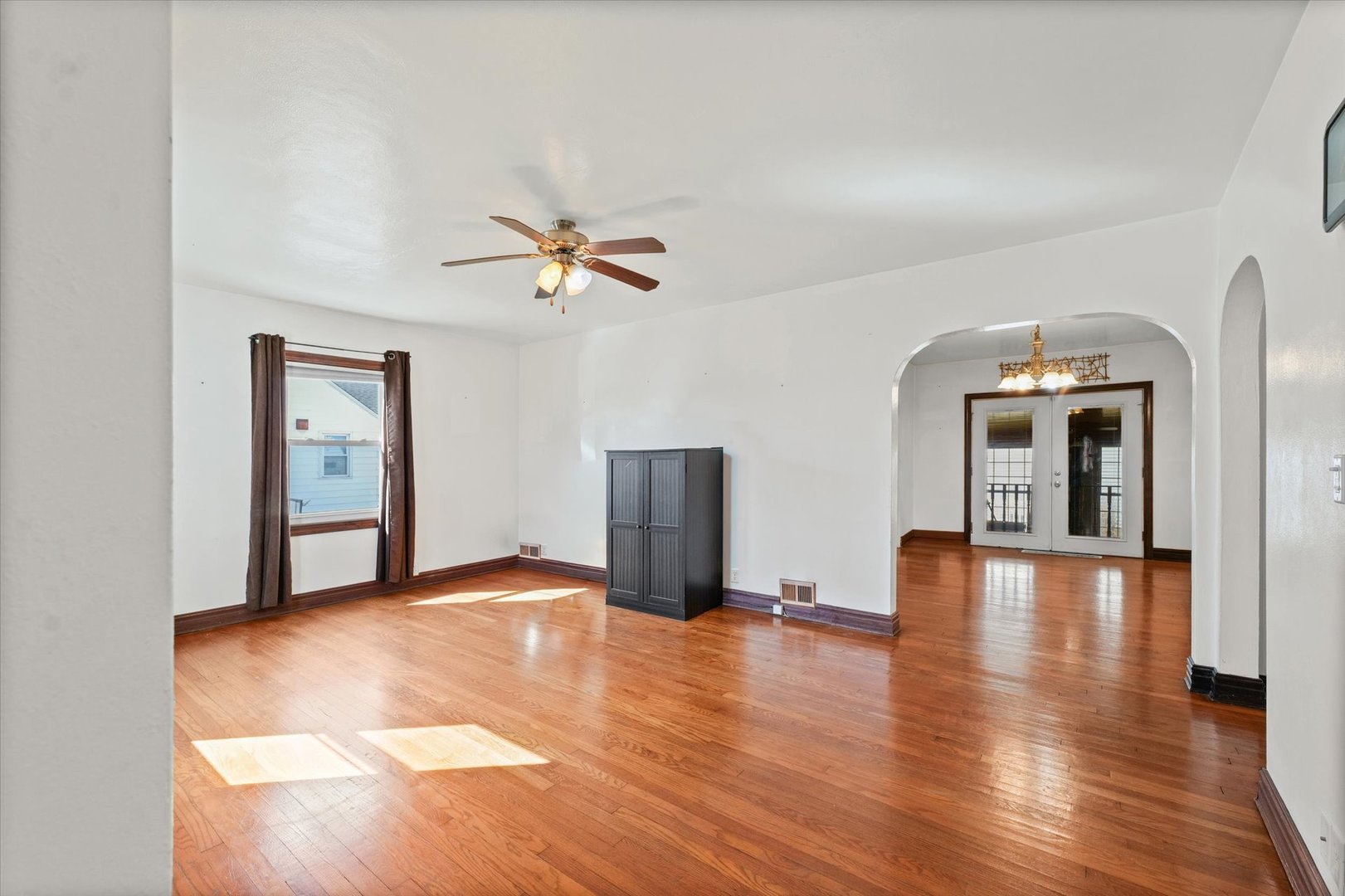 1608 West Springfield Avenue Champaign, IL 61821 - Photo 5 of 36 a view of an empty room with window and wooden floor