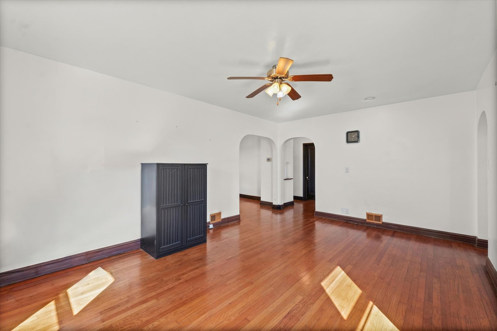 1608 West Springfield Avenue Champaign, IL 61821 - Photo 6 of 36 a view of room with wooden floor and ceiling fan
