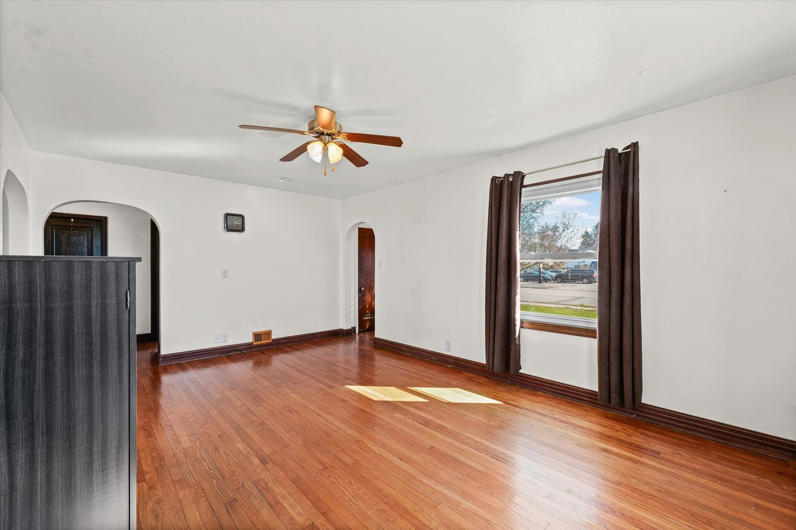 1608 West Springfield Avenue Champaign, IL 61821 - Photo 7 of 36 a view of empty room with wooden floor and fan