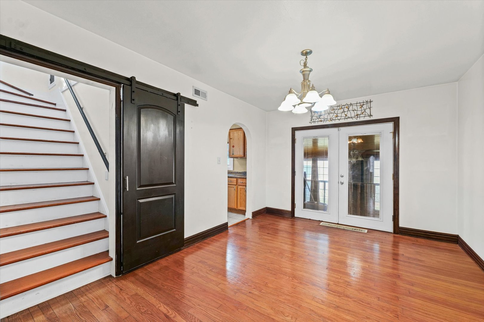 1608 West Springfield Avenue Champaign, IL 61821 - Photo 9 of 36 a view of a hallway with wooden floor and staircase