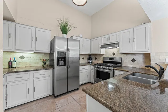 a kitchen with cabinets appliances and a counter space
