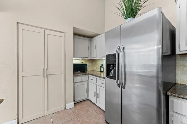 a kitchen with a refrigerator and a sink
