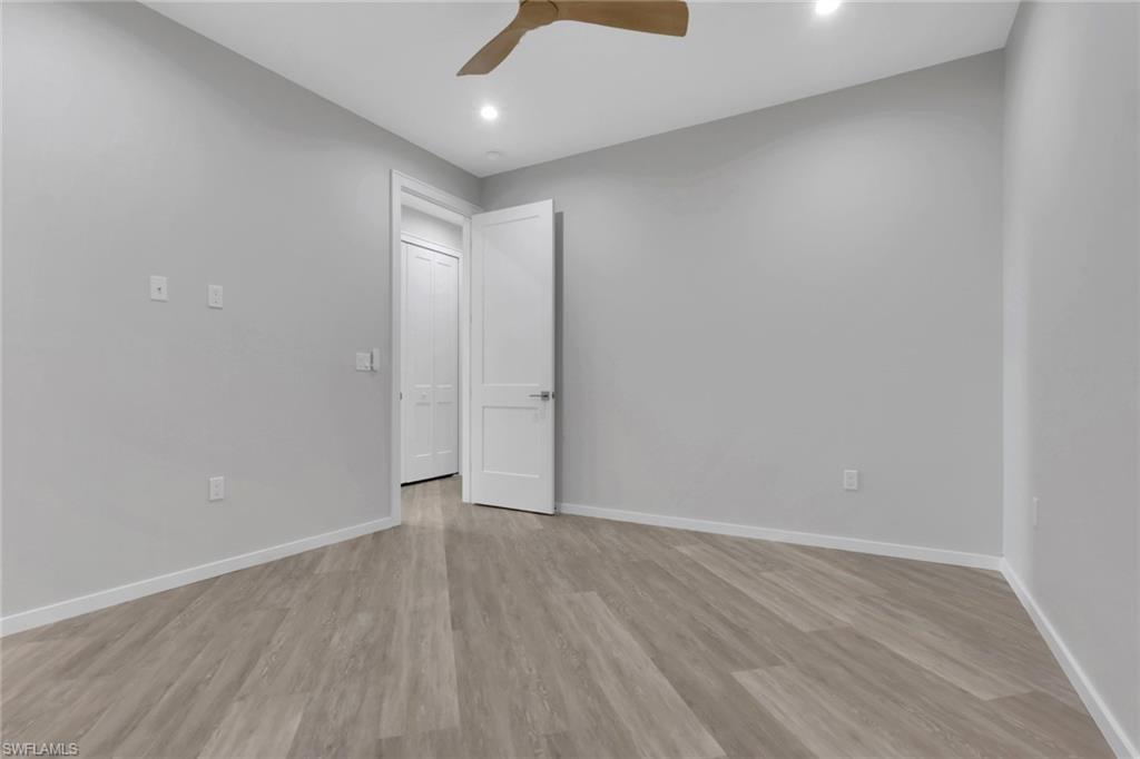 3500 Croton Road, Unit 101 Naples, FL 34104 - Photo 19 of 27 a view of an empty room with wooden floor