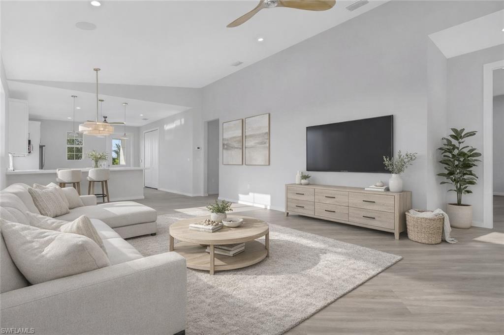 3500 Croton Road, Unit 101 Naples, FL 34104 - Photo 2 of 27 a living room with furniture and a flat screen tv