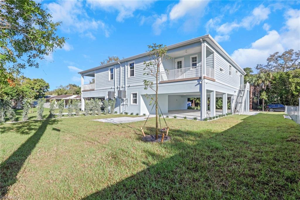 3500 Croton Road, Unit 101 Naples, FL 34104 - Photo 27 of 27 a view of house with a yard