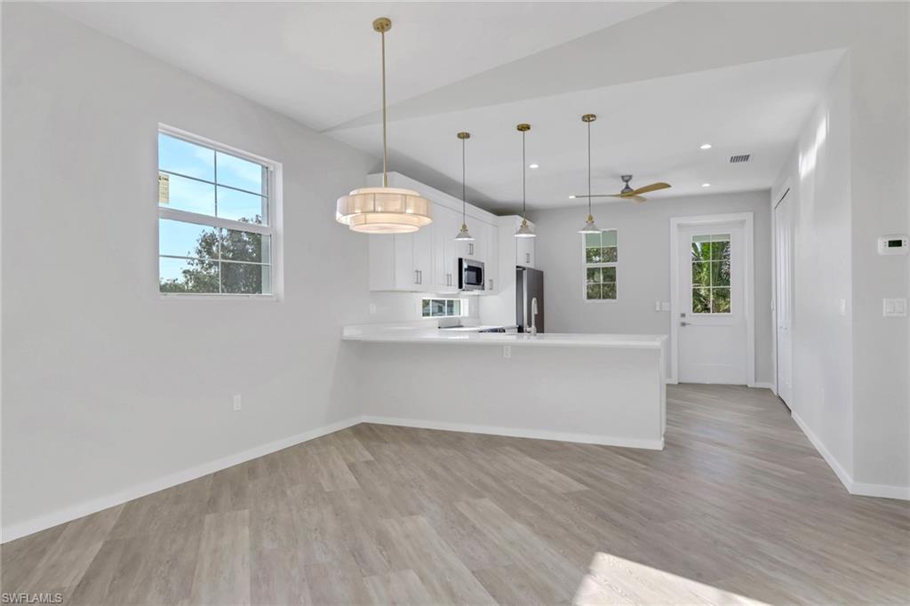 3500 Croton Road, Unit 101 Naples, FL 34104 - Photo 6 of 27 a view of a kitchen and wooden floor