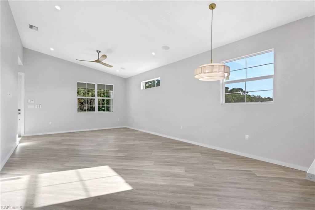 3500 Croton Road, Unit 101 Naples, FL 34104 - Photo 8 of 27 a view of an empty room with a window and wooden floor