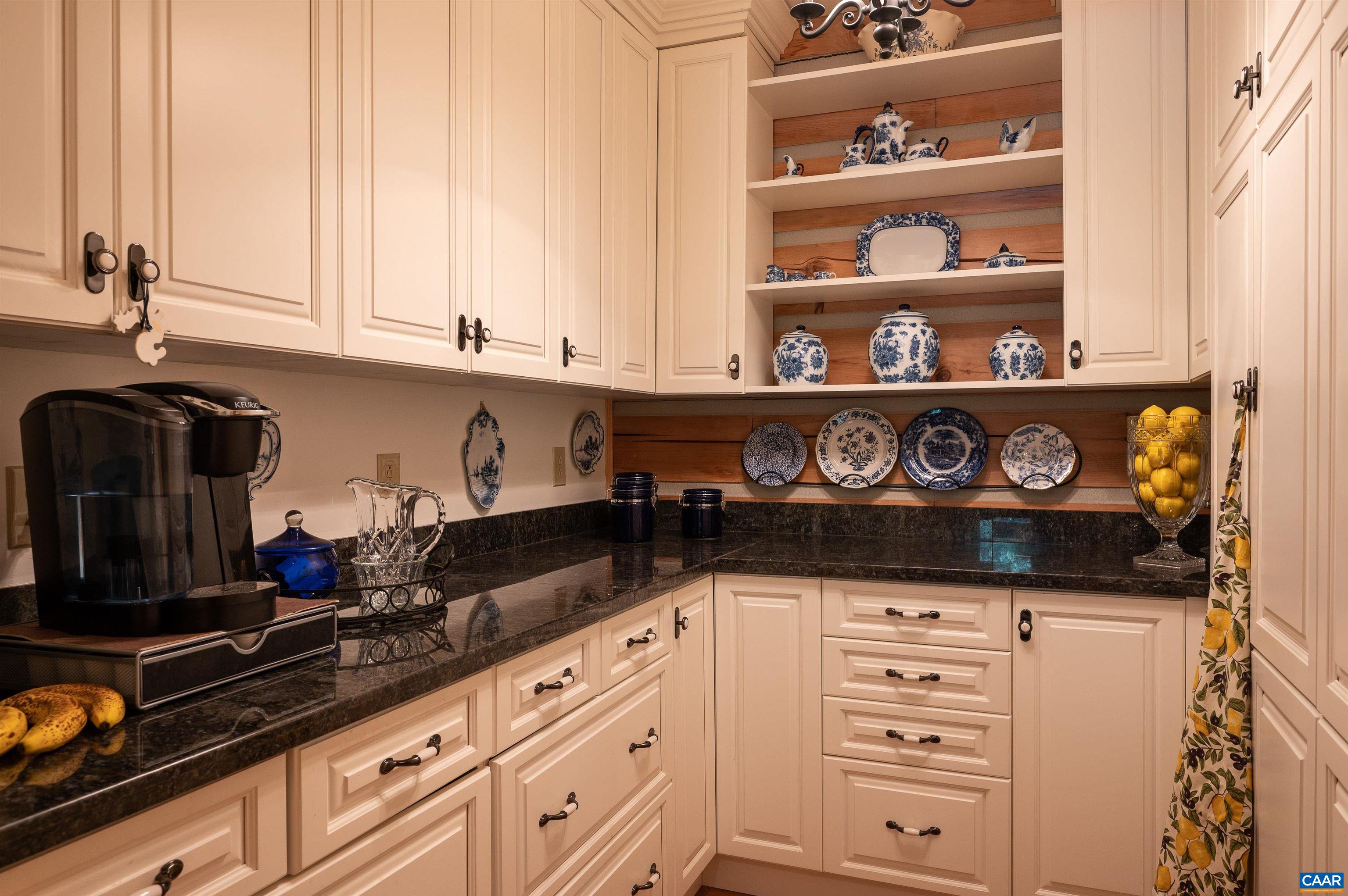 6721 Foster Ridge Charlottesville, VA 22903 - Photo 11 of 45 a kitchen with white cabinets and a wooden floor
