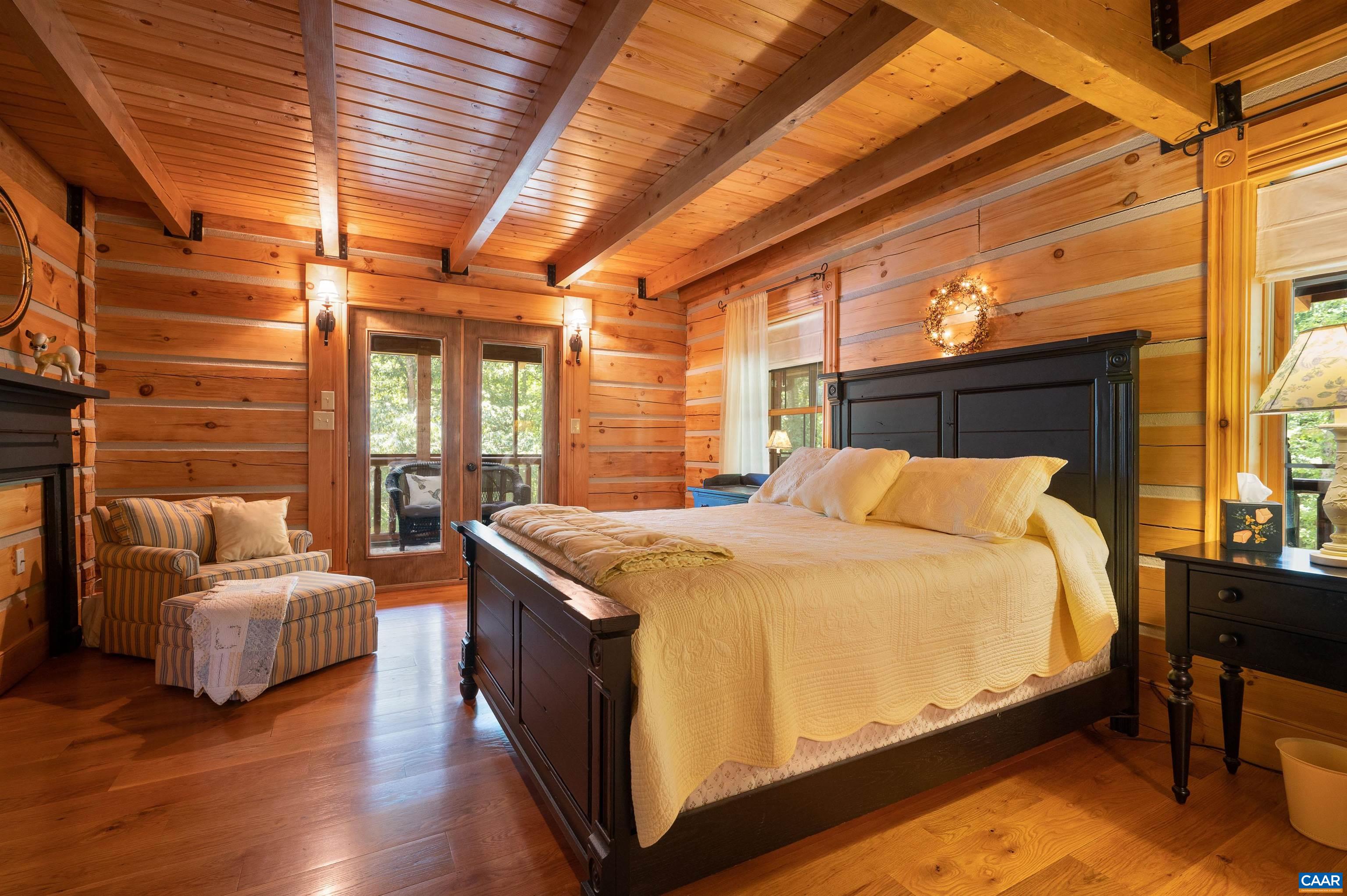 6721 Foster Ridge Charlottesville, VA 22903 - Photo 13 of 45 a bedroom with a bed and wooden floor