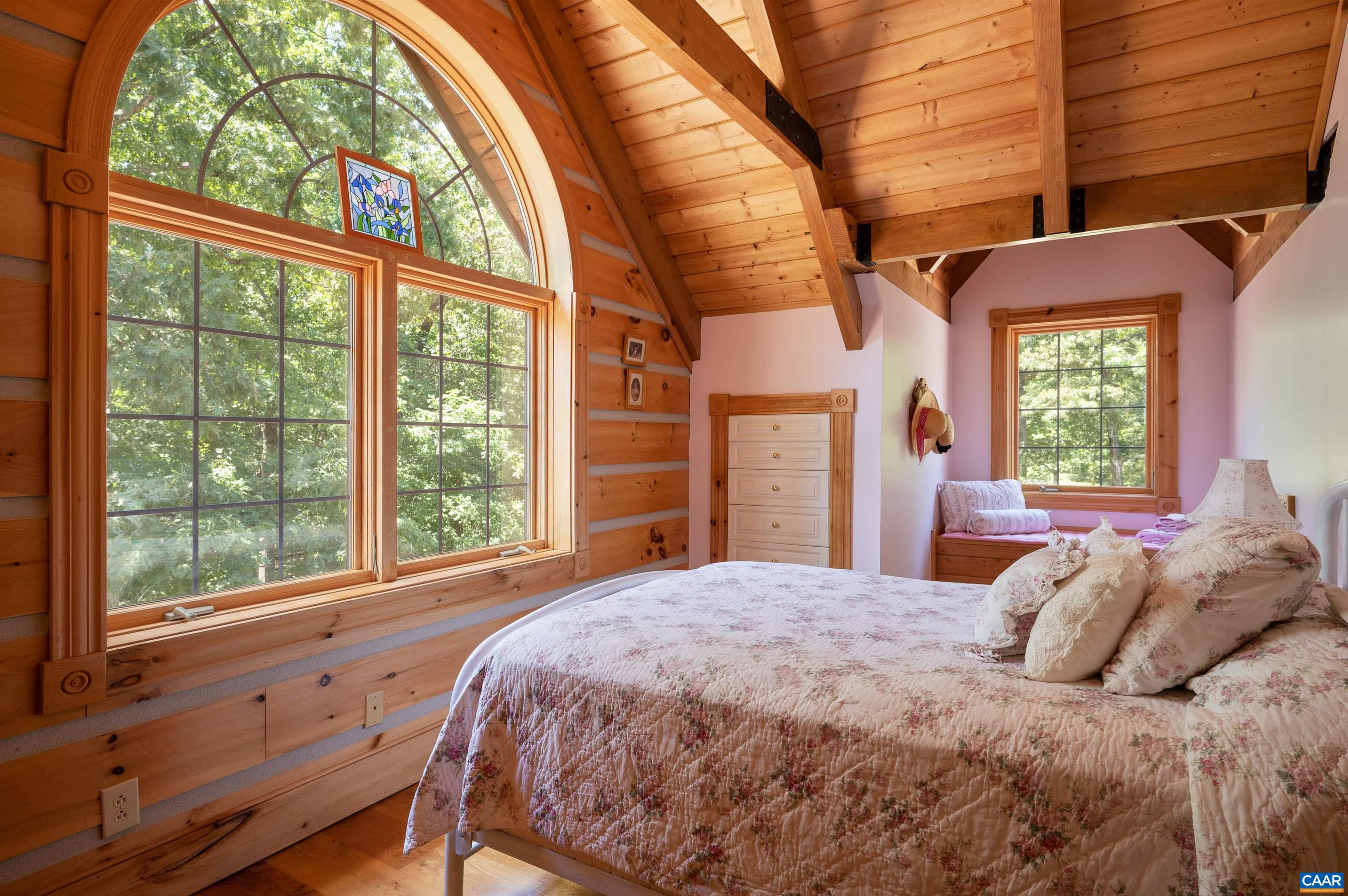 6721 Foster Ridge Charlottesville, VA 22903 - Photo 19 of 45 a bedroom with a large bed and a large window