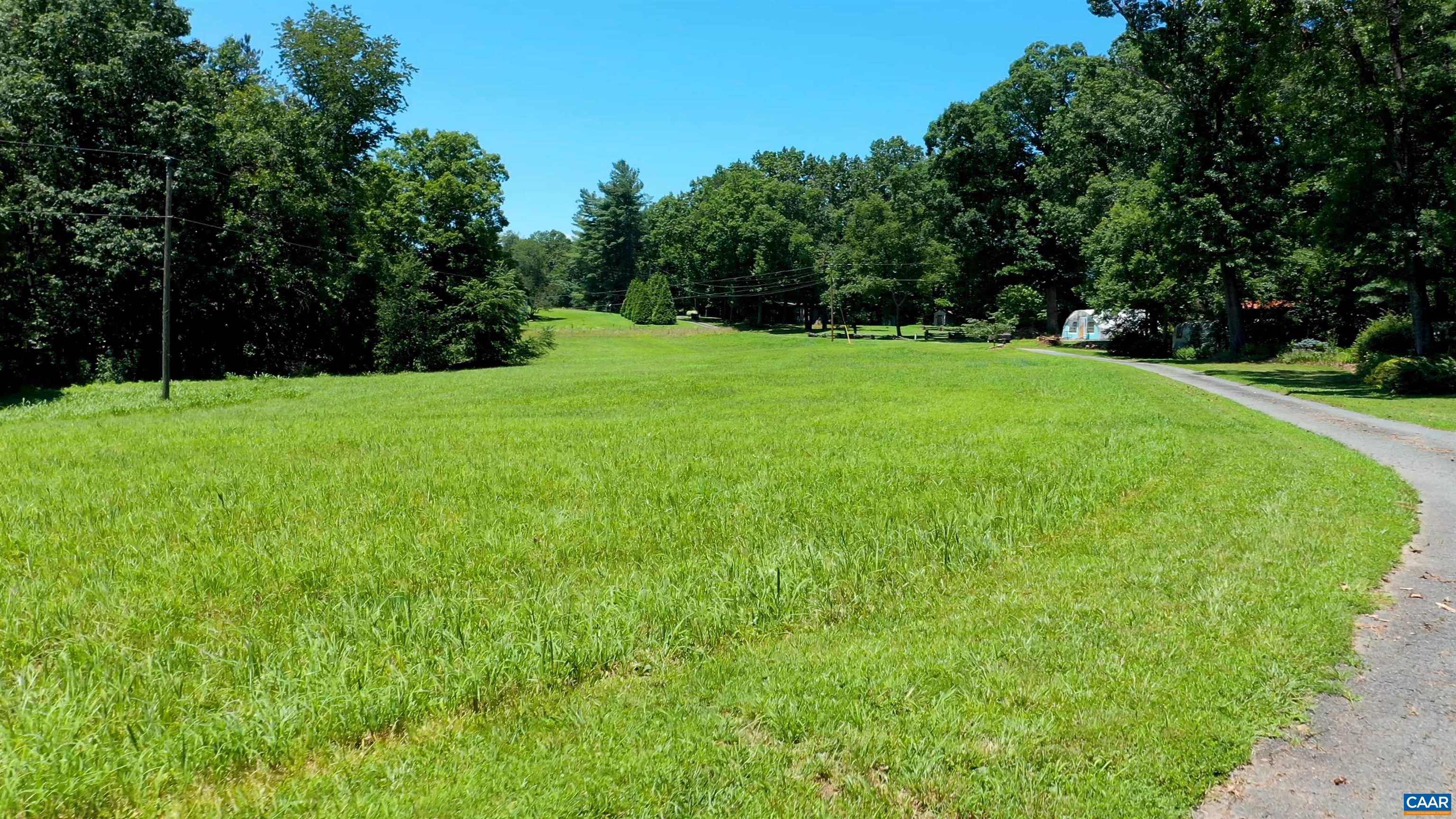 6721 Foster Ridge Charlottesville, VA 22903 - Photo 38 of 45 a view of a grassy field with trees in the background