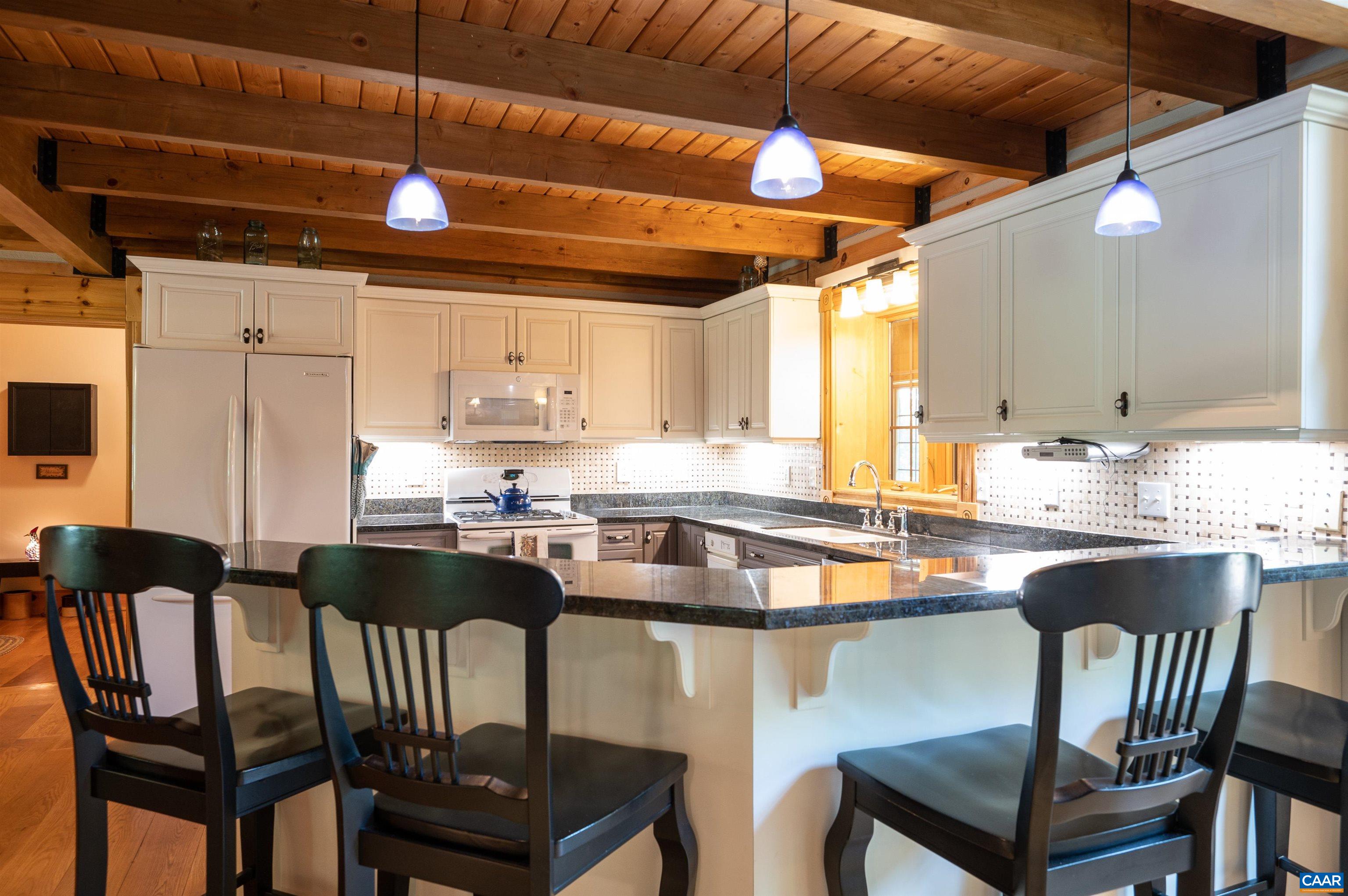 6721 Foster Ridge Charlottesville, VA 22903 - Photo 8 of 45 a kitchen with a dining table chairs and sink