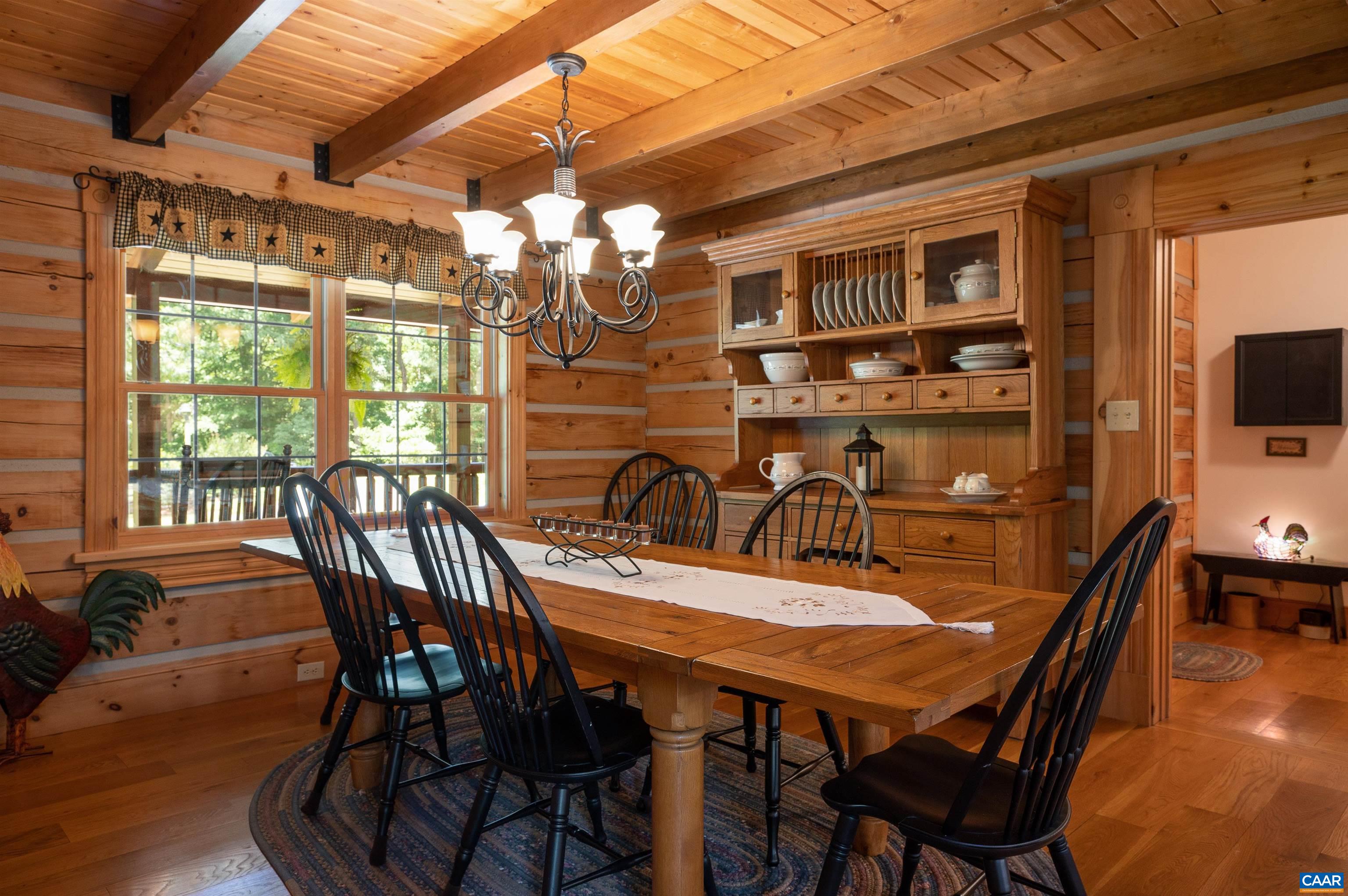 6721 Foster Ridge Charlottesville, VA 22903 - Photo 10 of 45 a view of a dining room with furniture a chandelier and wooden floor