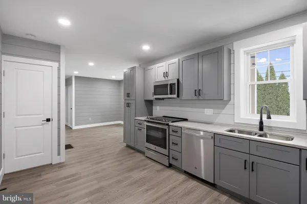 a kitchen with a sink stove and refrigerator