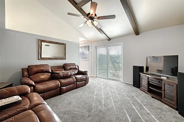 an empty room with chandelier fan