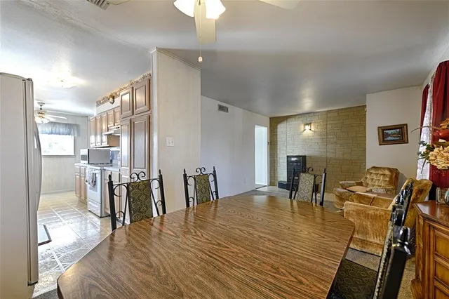 a dining room with furniture a floor to ceiling window and wooden floor
