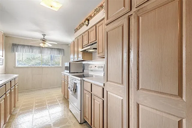 a kitchen with stainless steel appliances a refrigerator and a stove