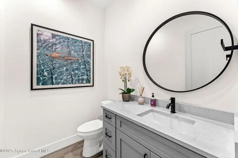 a living room with a bed furniture and a wooden floor