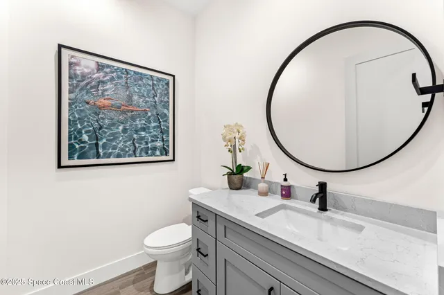a living room with a bed furniture and a wooden floor