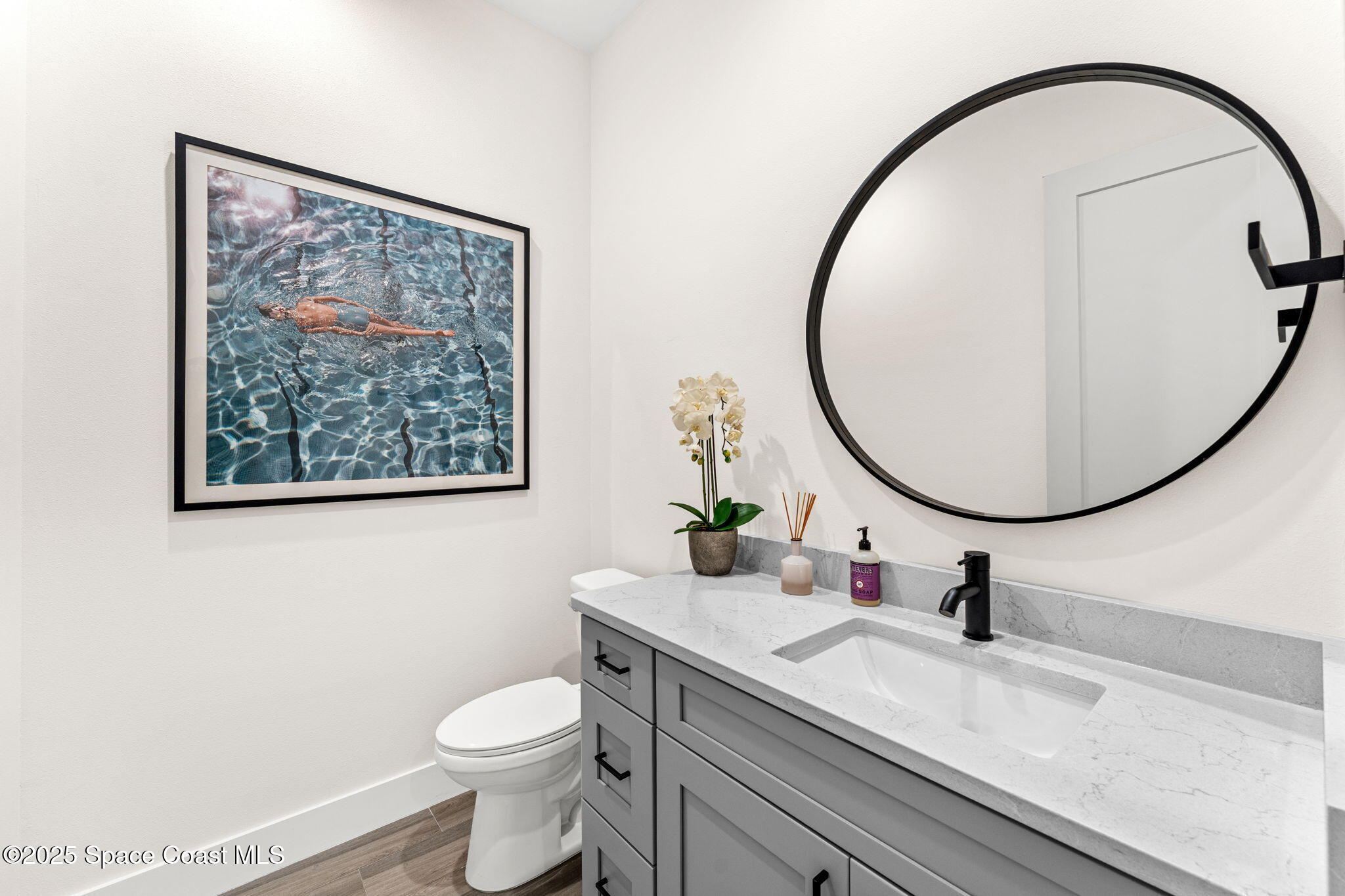 106 4th Avenue Indialantic, FL 32903 - Photo 12 of 37 a bathroom with a toilet a sink and a mirror