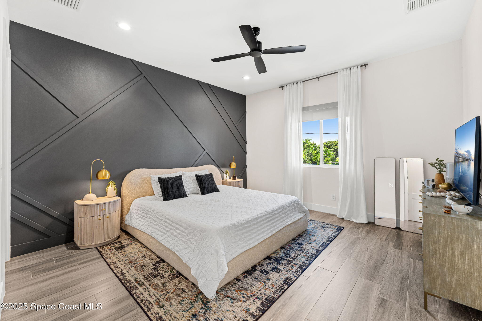 106 4th Avenue Indialantic, FL 32903 - Photo 13 of 37 a living room with a bed furniture and a wooden floor