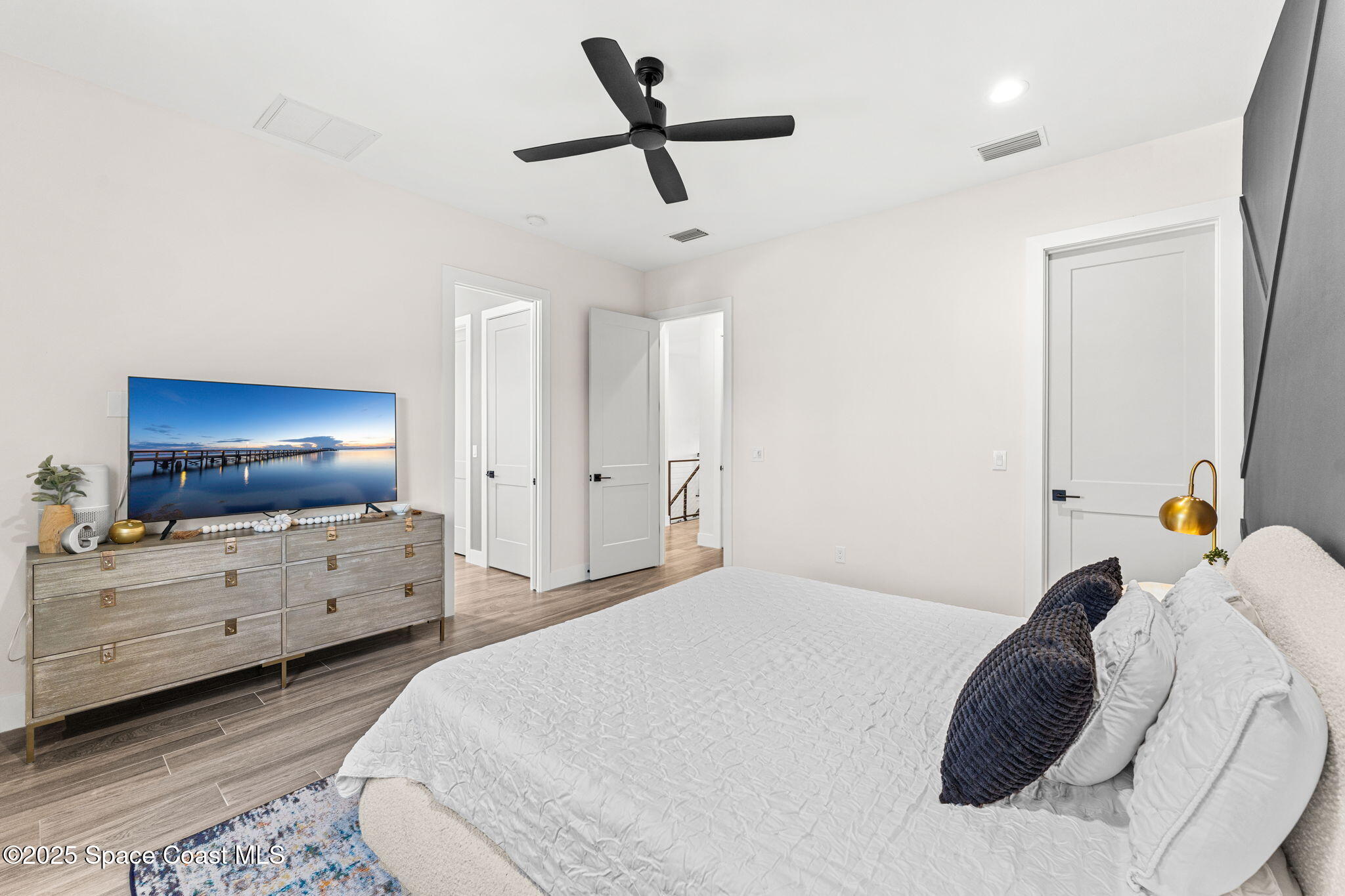 106 4th Avenue Indialantic, FL 32903 - Photo 14 of 37 a bedroom with a bed and flat screen tv