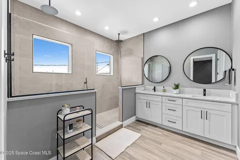 a view of a hallway with wooden floor and cabinet