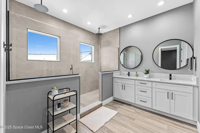 a view of a hallway with wooden floor and cabinet