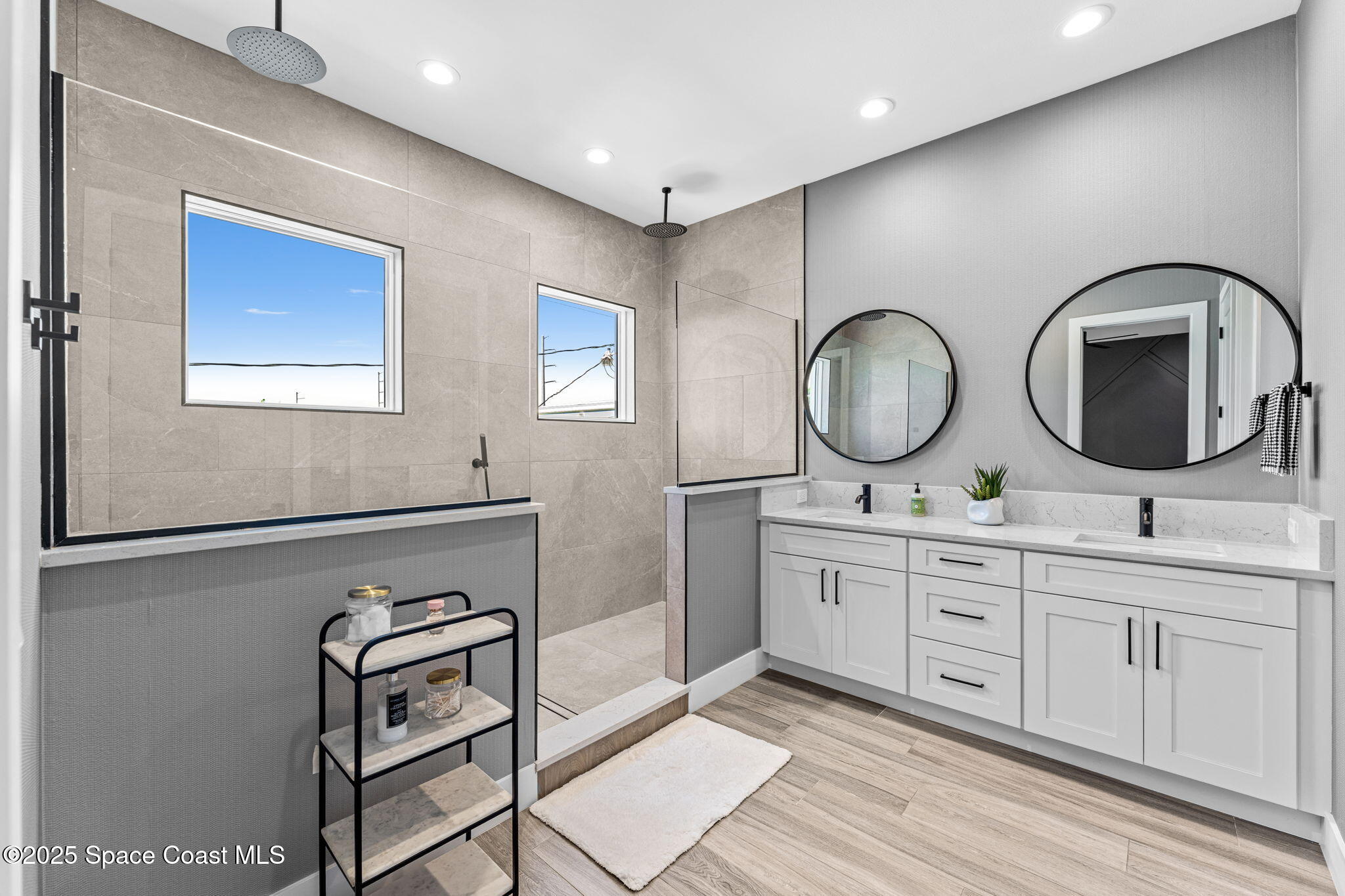 106 4th Avenue Indialantic, FL 32903 - Photo 15 of 37 a bathroom with double vanity sink and a mirror