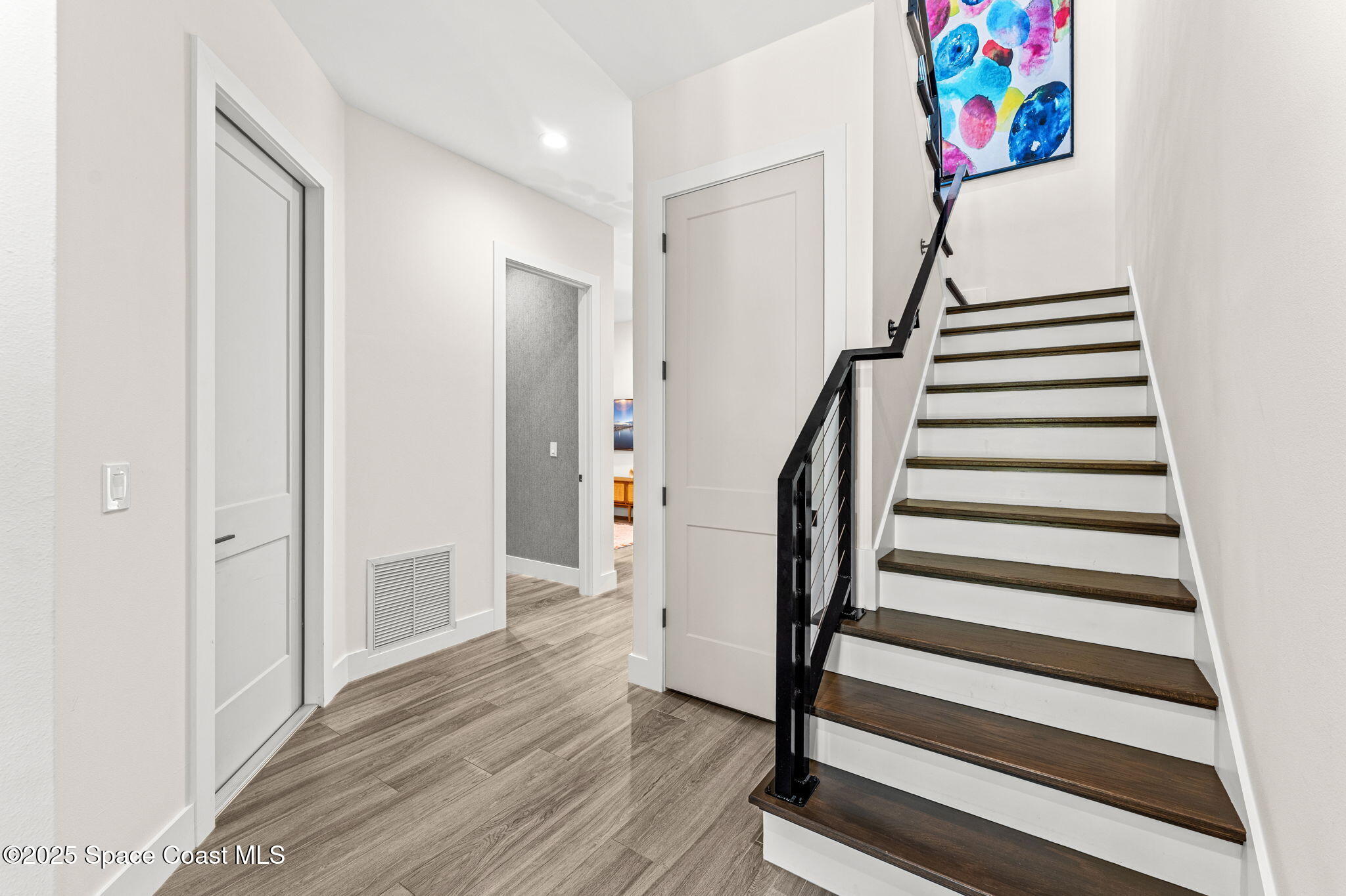 106 4th Avenue Indialantic, FL 32903 - Photo 17 of 37 a view of entryway with wooden floor and stairs
