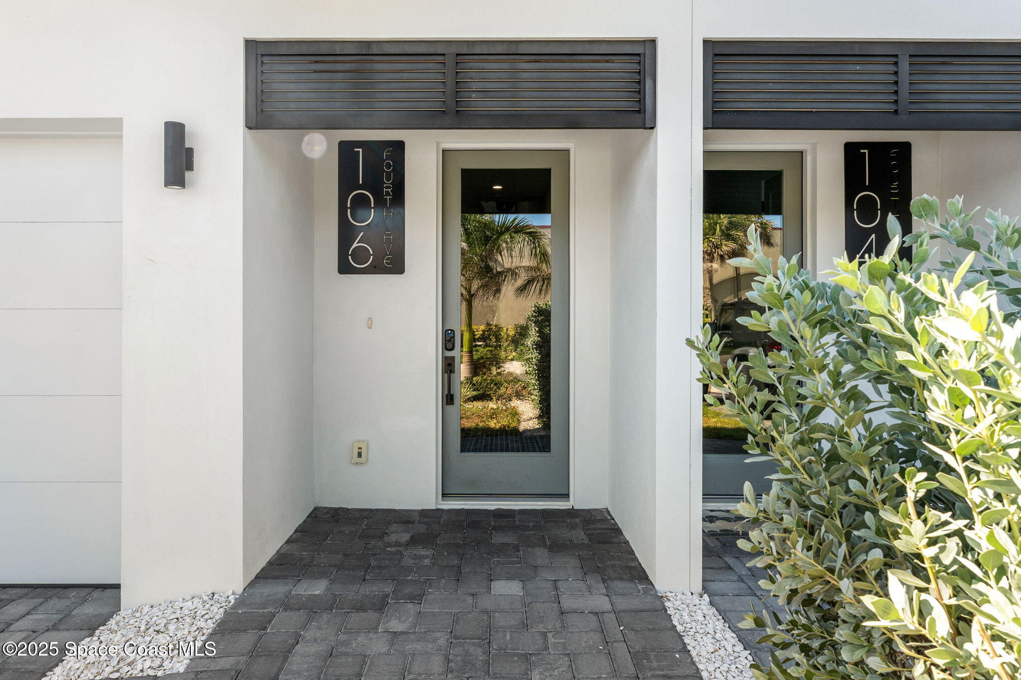 106 4th Avenue Indialantic, FL 32903 - Photo 29 of 37 front view of a brick house with a large door