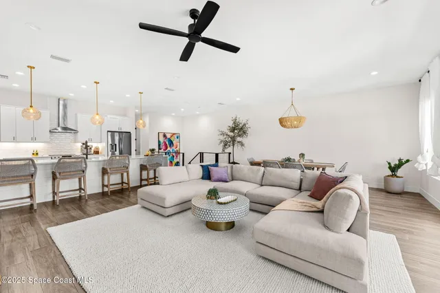 a large white kitchen with lots of counter space dining table and chairs