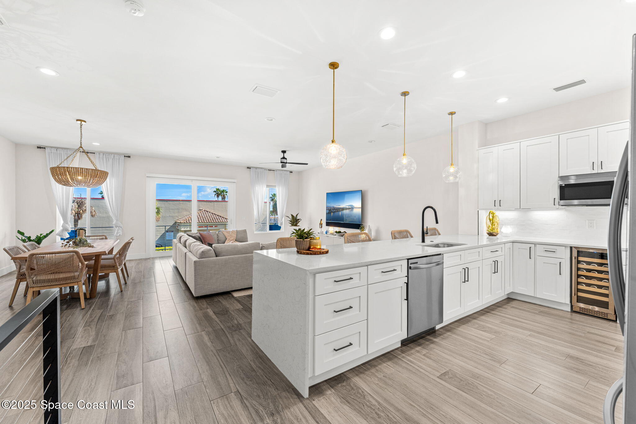 106 4th Avenue Indialantic, FL 32903 - Photo 4 of 37 a large white kitchen with lots of counter space dining table and chairs