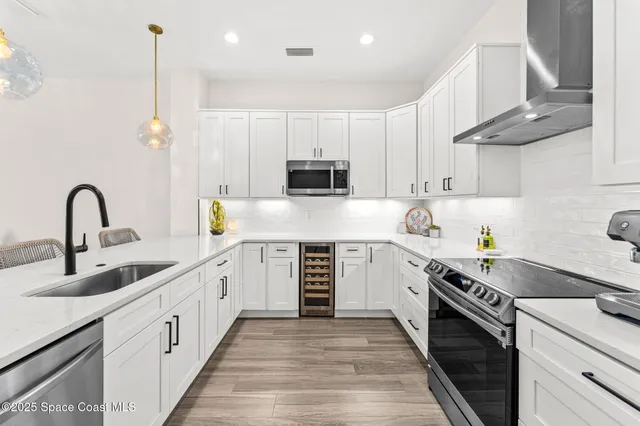 a kitchen with stainless steel appliances granite countertop a stove and a refrigerator