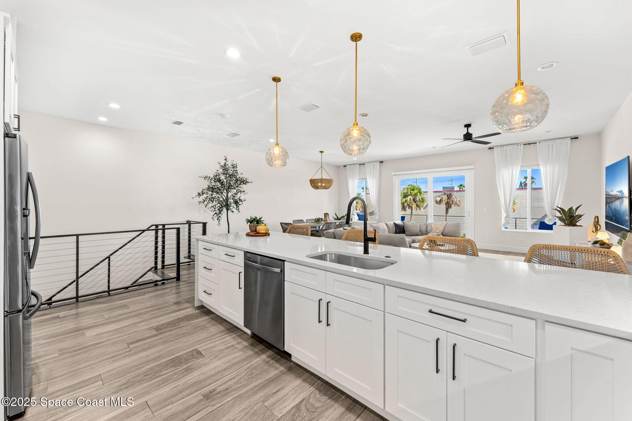 106 4th Avenue Indialantic, FL 32903 - Photo 10 of 37 a view of a kitchen with kitchen island a sink stainless steel appliances and a counter top space