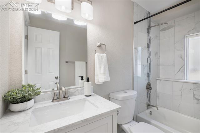 624 Wheat Field Road Fountain, CO 80817 - Photo 25 of 26 Full bathroom featuring tiled shower / bath combo, toilet, and vanity