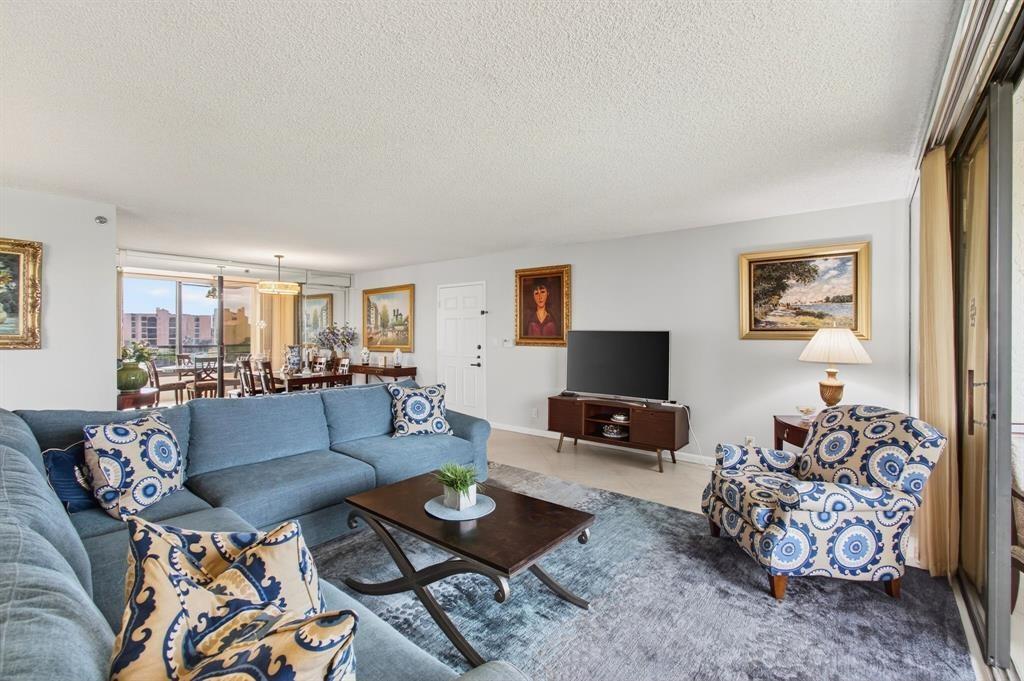 7145 Promenade Drive, Unit 602 Boca Raton, FL 33433 - Photo 14 of 90 a living room with furniture and a flat screen tv
