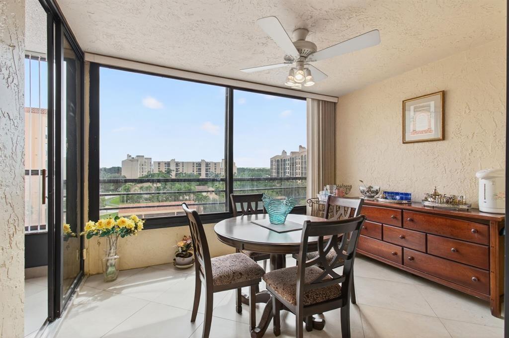 7145 Promenade Drive, Unit 602 Boca Raton, FL 33433 - Photo 26 of 90 a dining room with furniture a chandelier and a rug