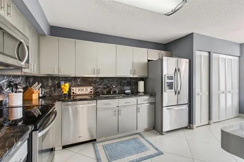 a large white bathroom with a sink a large mirror and shower