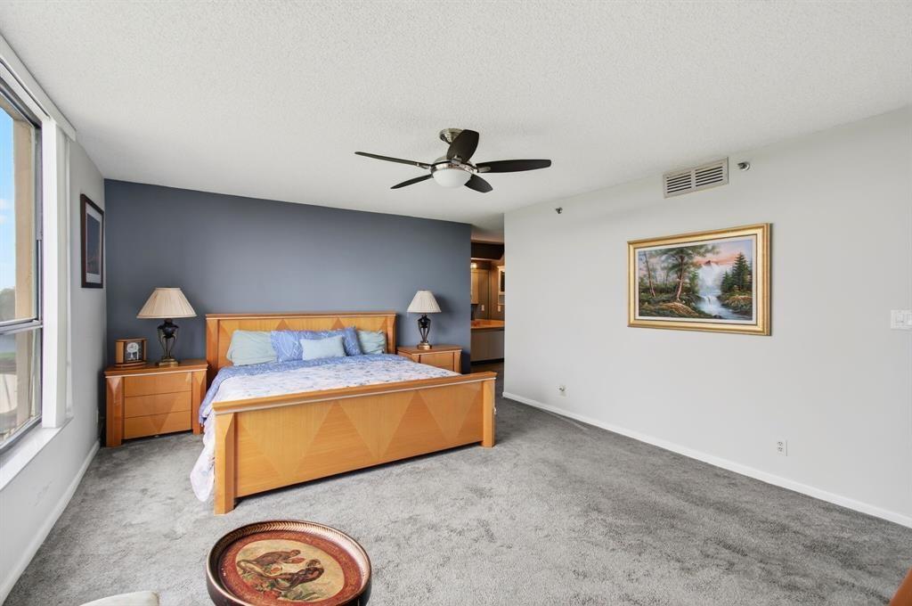 7145 Promenade Drive, Unit 602 Boca Raton, FL 33433 - Photo 41 of 90 a bed room with a bed and a chandelier