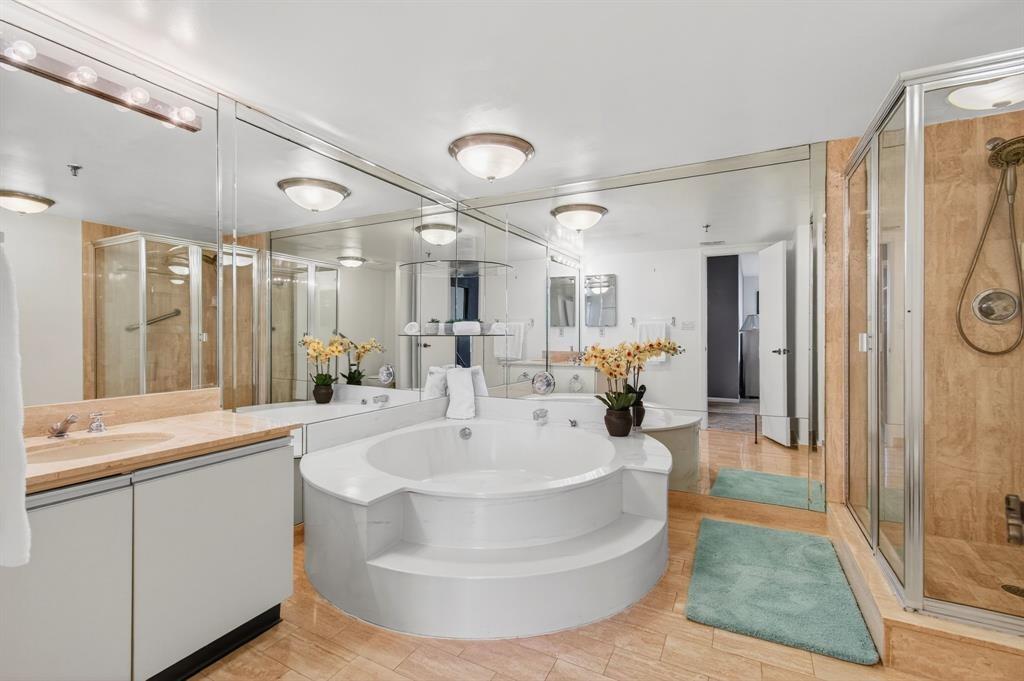 7145 Promenade Drive, Unit 602 Boca Raton, FL 33433 - Photo 46 of 90 a large white bathroom with a sink a large mirror and shower