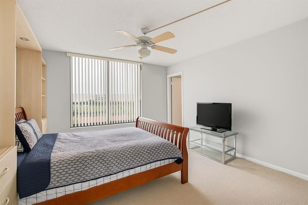 7145 Promenade Drive, Unit 602 Boca Raton, FL 33433 - Photo 51 of 90 a bedroom with a bed and a flat screen tv