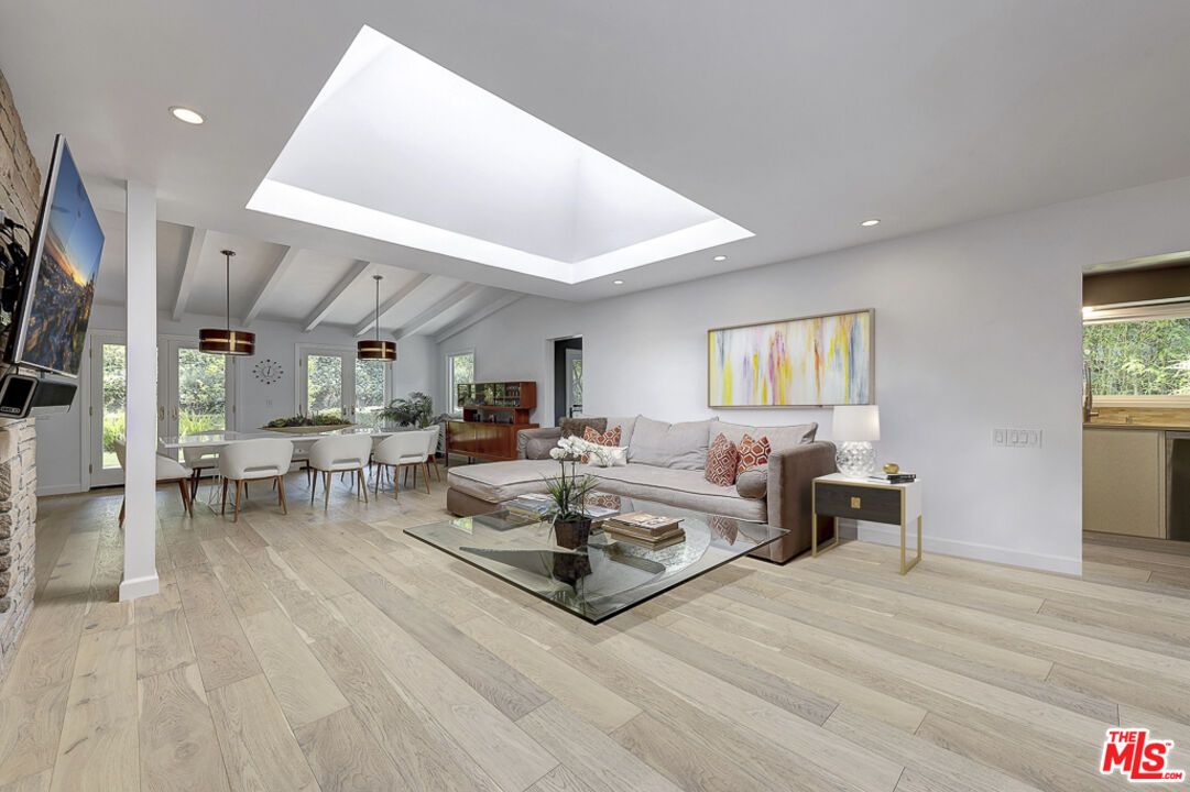 16012 Meadowcrest Road Sherman Oaks, CA 91403 - Photo 14 of 52 a living room with furniture and a flat screen tv