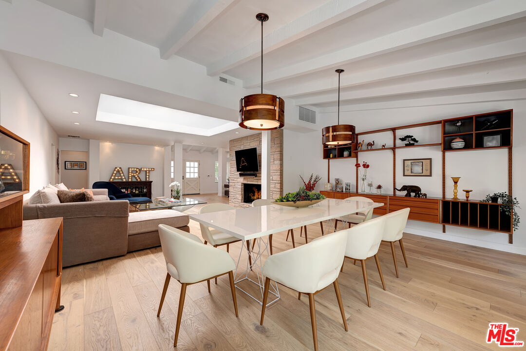 16012 Meadowcrest Road Sherman Oaks, CA 91403 - Photo 15 of 52 a view of a dining room with furniture window and wooden floor