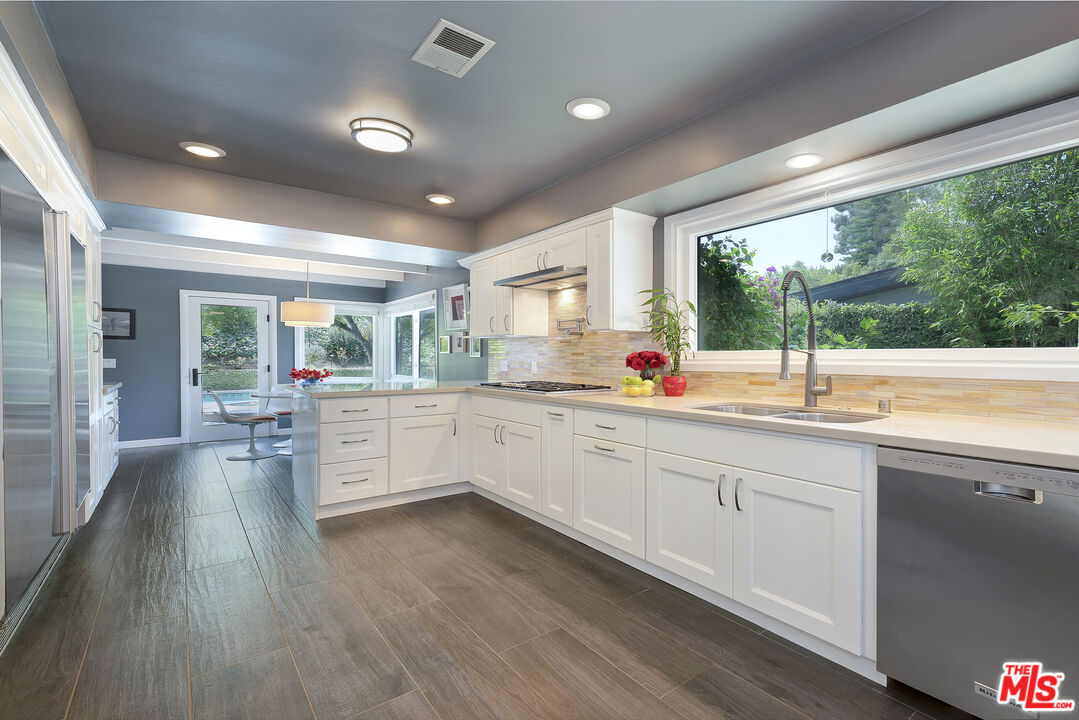 16012 Meadowcrest Road Sherman Oaks, CA 91403 - Photo 16 of 52 a kitchen with sink and wooden floor